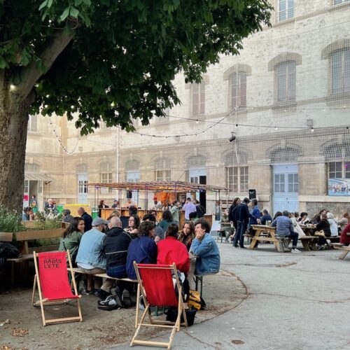 Cour du lycée jacques Decour avec transats rouges, table de ping pong et bar du lycée