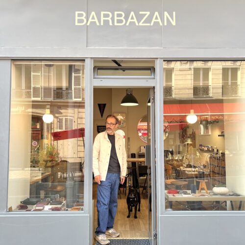 Vitrine sur rue de l'atelier Barbazan. Fabien dans l'encadrure de la porte, Au fond, son chien.