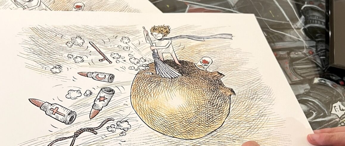 La main de Kianoush signant son dessin représentant le Petit Prince balayant la terre de toutes les bombes